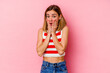 © Asier - Young caucasian woman isolated on pink background shocked, covering mouth with hands, anxious to discover something new.