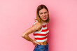 © Asier - Young caucasian woman isolated on pink background suffering a back pain.