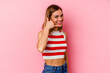 © Asier - Young caucasian woman isolated on pink background showing a mobile phone call gesture with fingers.