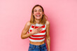 © Asier - Young caucasian woman isolated on pink background laughs out loudly keeping hand on chest.