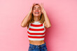 © Asier - Young caucasian woman isolated on pink background laughs joyfully keeping hands on head. Happiness concept.