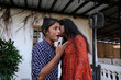 Indian female friends talking and discussing something near an old house