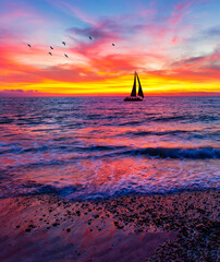 sunset ocean sailboat vertical