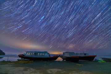 Wall Mural - The milky way and star trails in the sky , lake side.