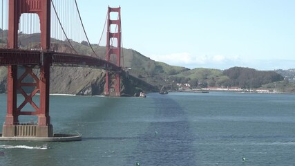 Wall Mural - Ships and kayaks sailing underneath the popular Golden Gate Bridge in San Francisco 