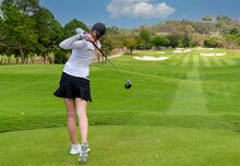 Professional Woman Golfer Teeing Golf In Golf Tournament Competition At Golf Course For Winner.  