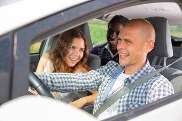 Group of best friends travel together, they driving in car and making fun