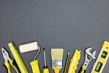 Poster - set of working tools for construction or home repair works on dark grey background. flat lay.