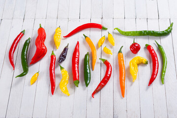 Wall Mural - chili pepper selection on white wood table background