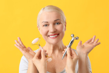 Sticker - Mature woman with facial massage tools on color background