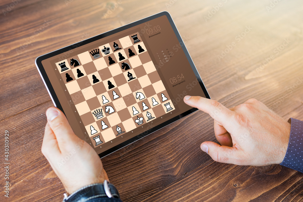 Man playing chess online on tablet computer