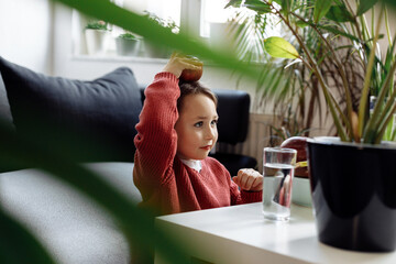 Little girl holding apple on head, healthy lifestyle concept