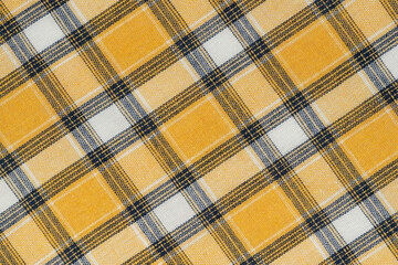 Yellow white tartan texture background. shirt fabric with a checkered pattern. factory material