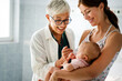 © NDABCREATIVITY - Mother holding baby for pediatrician doctor to examine