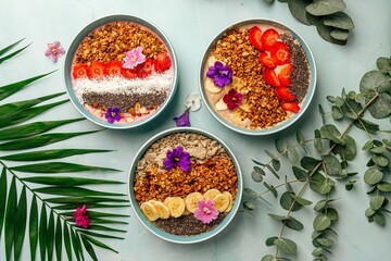 Wall Mural - Top view on dfferent smoothie bowls with fruits and granola 