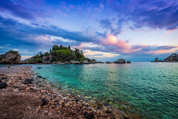 Wall Mural - Turquoise water and violet sunset sky on the beach of Isola bella in Taormina, Sicily