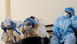 Group of doctors in protective medical uniform getting stressed over the Covid-19 pandemic