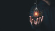 © Dilok - Man hand holding hanging glowing drawing light bulb with orange rays , creative thinking idea and innovation concept.