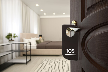 Wooden door open into modern hotel room, closeup