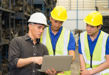 Men work together, diversity of Caucasian manager order two Asian engineer workers in factory-warehouse