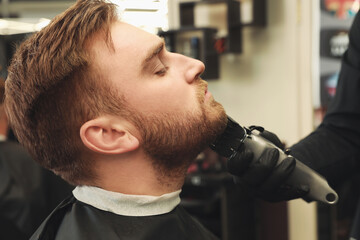 Sticker - Professional hairdresser working with client in barbershop