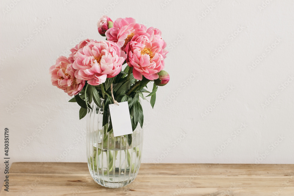Floral still life scene. Pink peonies flowers, bouquet in glass vase on ...