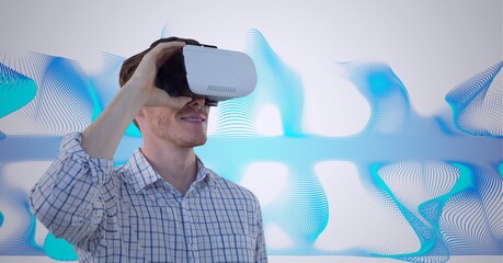 Poster - Composition of smiling man wearing vr headset over blue light trails