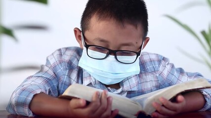 Wall Mural - Child reading a Bible, Christian concept.