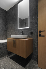 Wall Mural - Modern minimalist bathroom dark interior design with dark stone tiles and wood furniture