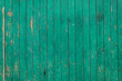 Wooden boards with old green paint close-up.