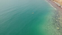 Dead Sea Waterscape With Couple Floating