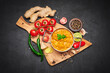 Pot of Traditional Chicken Curry and spices on wooden servig cutting board