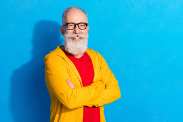 Poster - Photo of happy good mood smiling cheerful mature businessman with folded hands representative isolated on blue color background