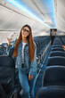 © Viacheslav Yakobchuk - Beautiful young woman standing in the passenger aircraft alone