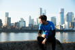 © Image Source RF - UK, London, Jogger looking at downtown skyline in background