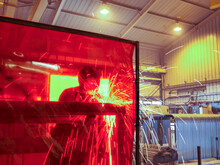 UK, Doncaster, Engineer Welding In Factory
