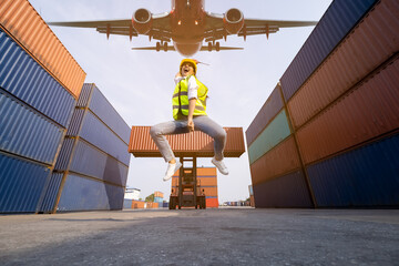  asian women foreman  jumping over in work area warehouse container and air plane background . happy summer holiday concept