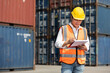 © offsuperphoto - factory worker or engineer writing on clipboard in containers warehouse storage