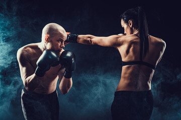 Wall Mural - Shirtless Woman exercising with trainer at boxing and self defen