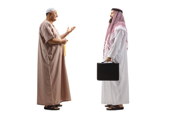 Canvas Print - Full length profile shot of a mullah talking to a saudi arab businessman