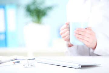 Poster - Computer keyboard with mouse and female hands holding cup of coffee