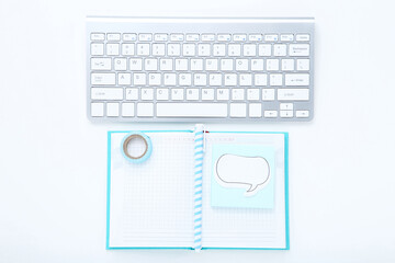 Poster - Computer keyboard with notepad, pen and speech bubble on white background