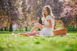 Beautiful young woman having picnic