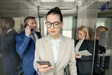 Poster - Office employees working in elevator
