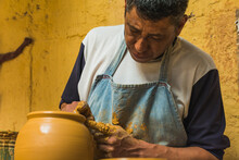 Mexican Potter Craftsman, Working The Clay With His Hands In His Workshop To Create Sculptures, Vases, Jugs, Vases Etc, Using Traditional Methods.