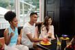 © etonastenka - Three friends are talking in a cafe. Friendship, communication, quarantine end concept