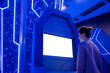 © zyabich - Woman looking at blank digital interactive white display kiosk at exhibition or museum with futuristic sci-fi blue interior. Mock up, copyspace, template, white screen, technology concept