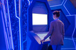 © zyabich - White screen, mock up, future, copyspace, technology concept. Woman looking at blank interactive touchscreen white display of electronic kiosk at exhibition or museum with sci-fi blue interior