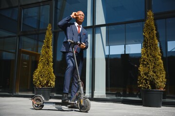 Young African businessman Riding An Electric Scooter