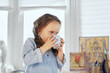© boytsov - Cute thirsty girl is drinking water from the cup. Small schoolgirl having fresh beverage. Tasty drinking. High quality image